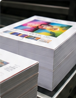 Stacks of freshly printed full-colour sheets